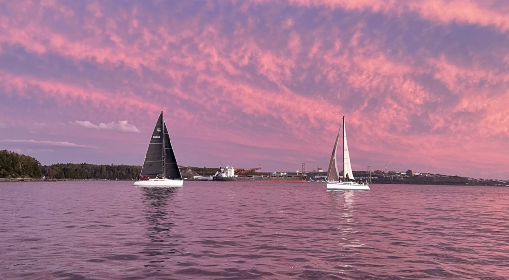 Sailboats racing at sunset
